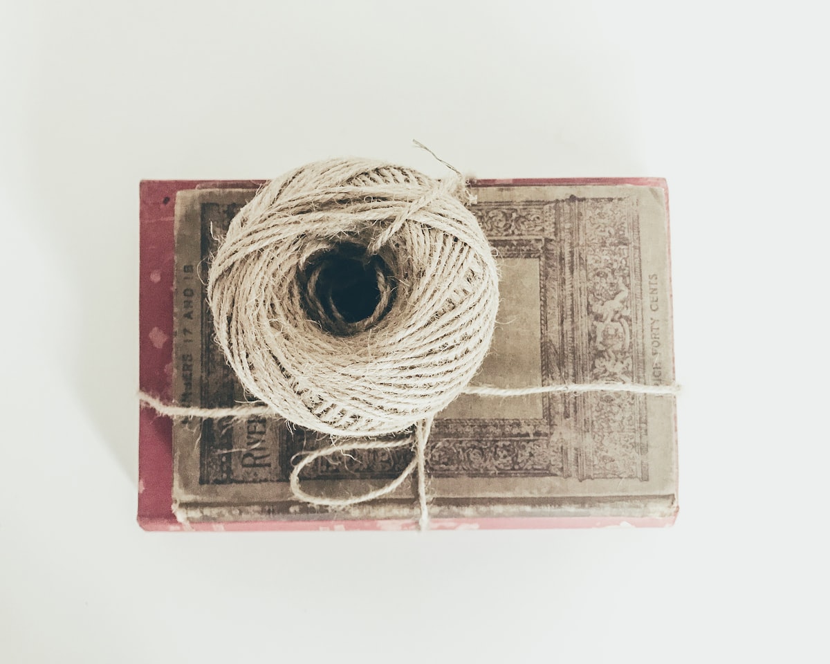 A book wrapped in paper and tied with twine