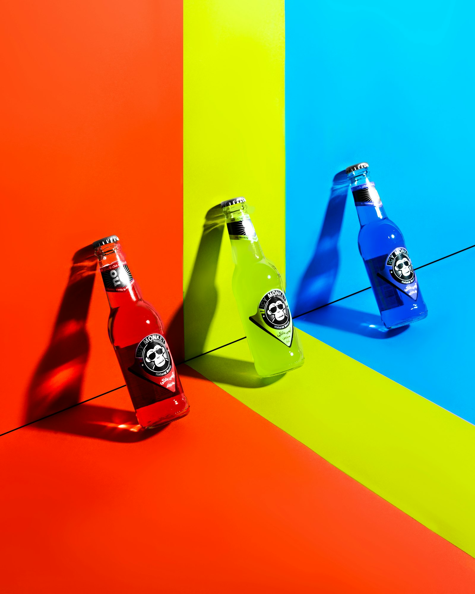 Colorful soda bottles on bright color blocks