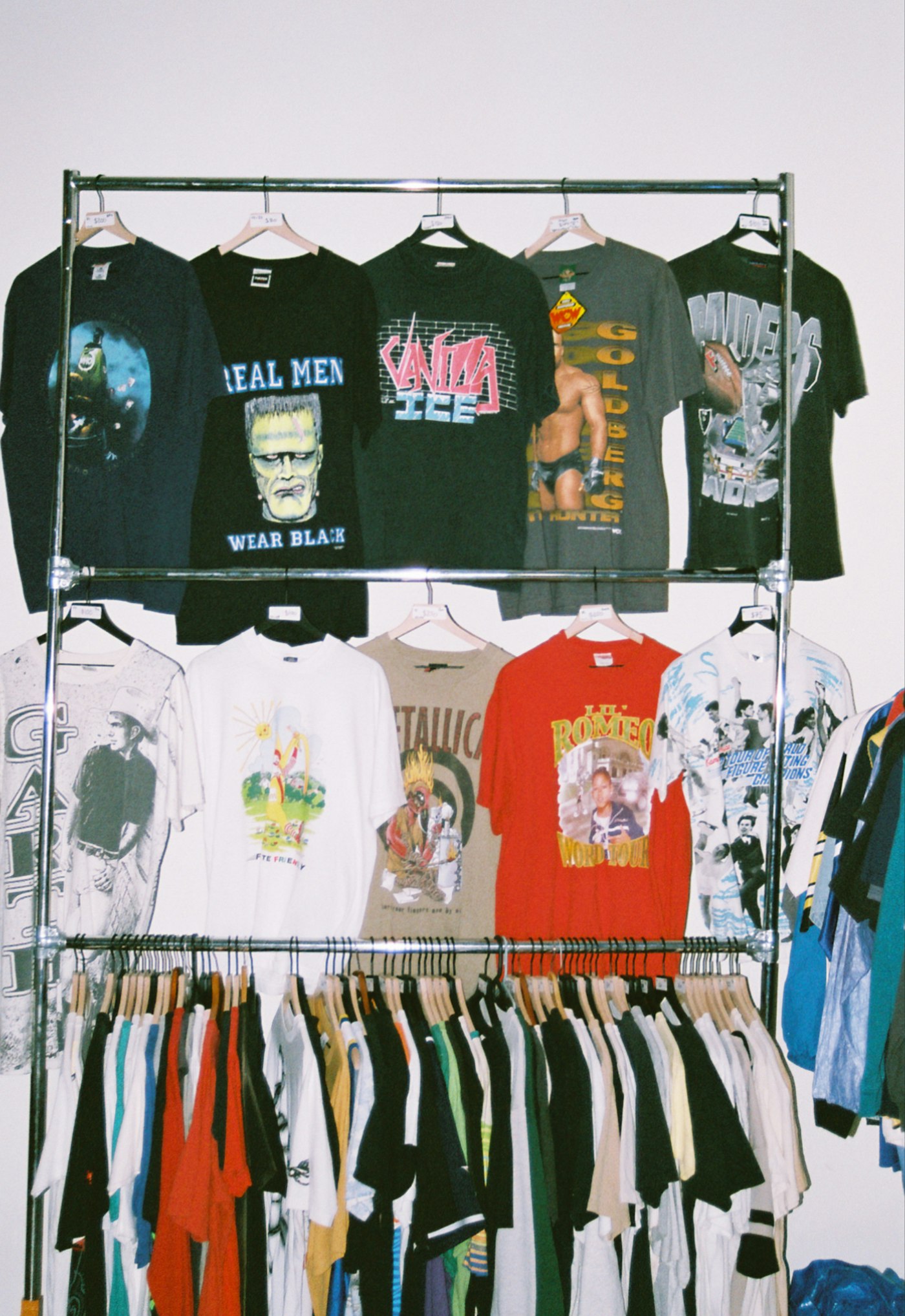 Rack of vintage tees and thrifted clothing