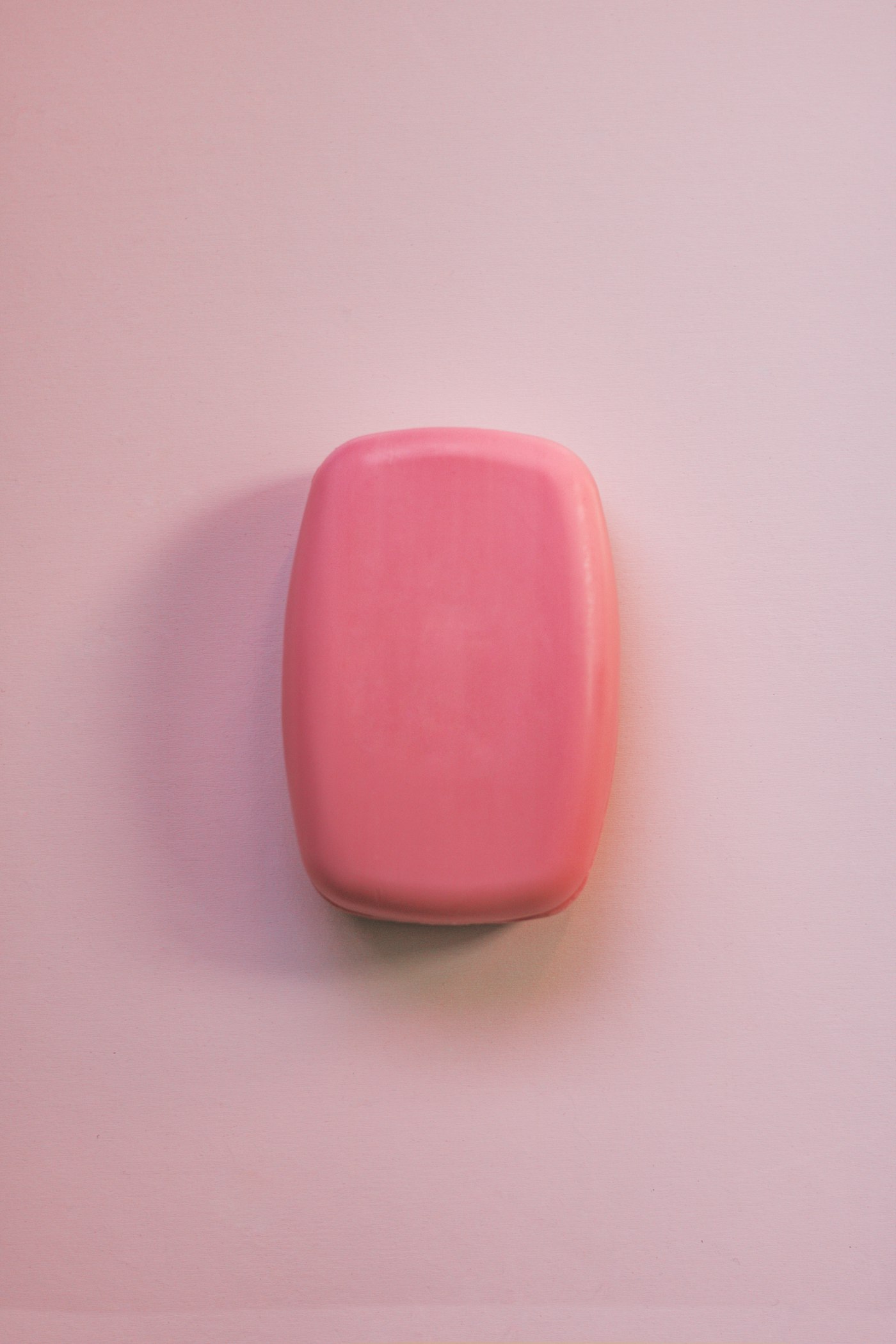 Pink handmade soap bar on a blush background