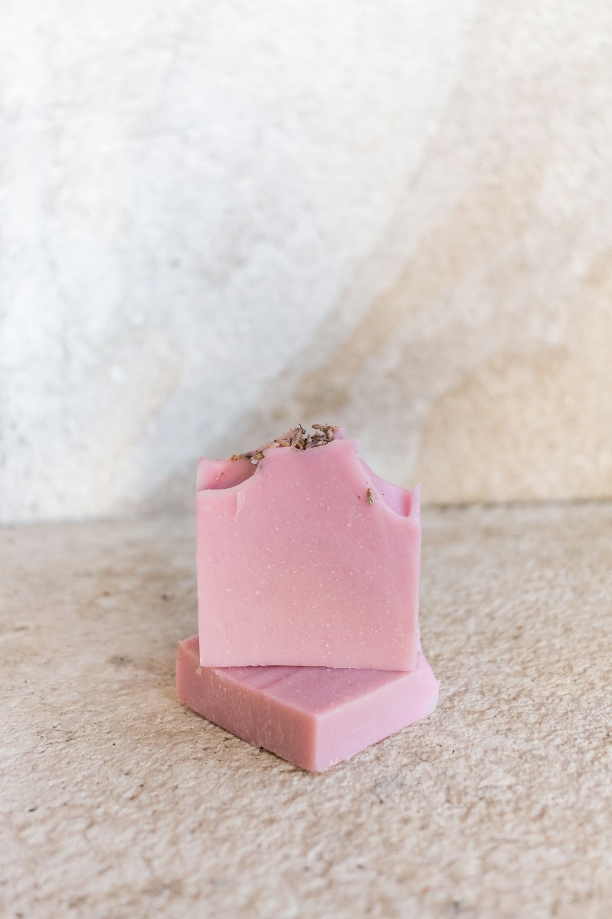Pink rose soap bars stacked on stone