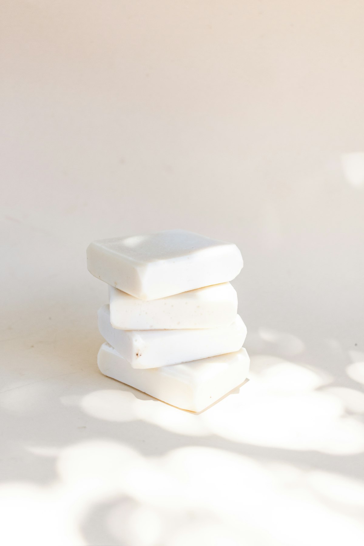 Creamy white soap bars stacked in sunlight