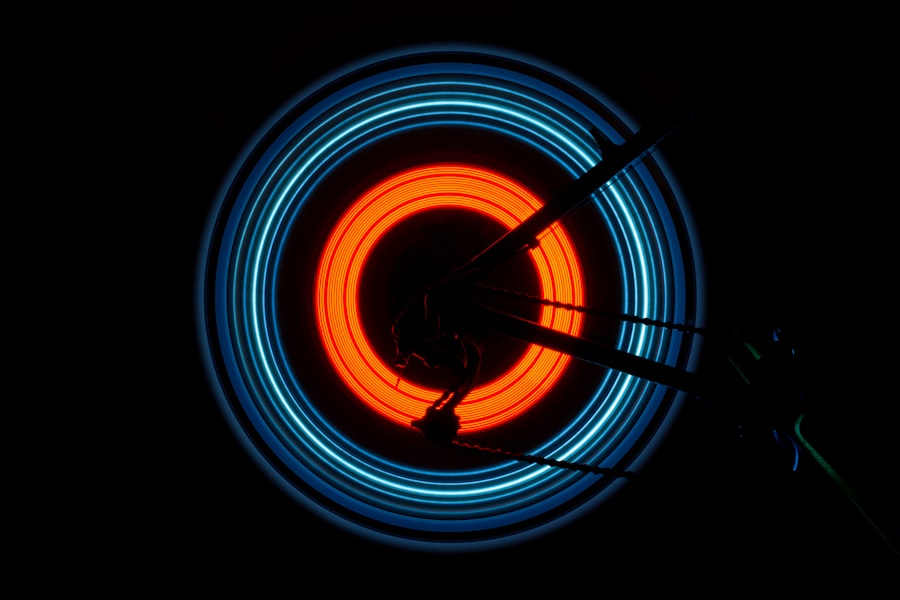 Spinning bike wheel traced by blue and orange light rings