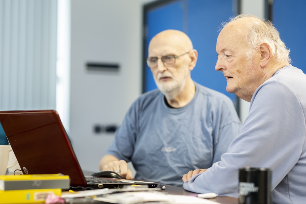 Two people working on a laptop together