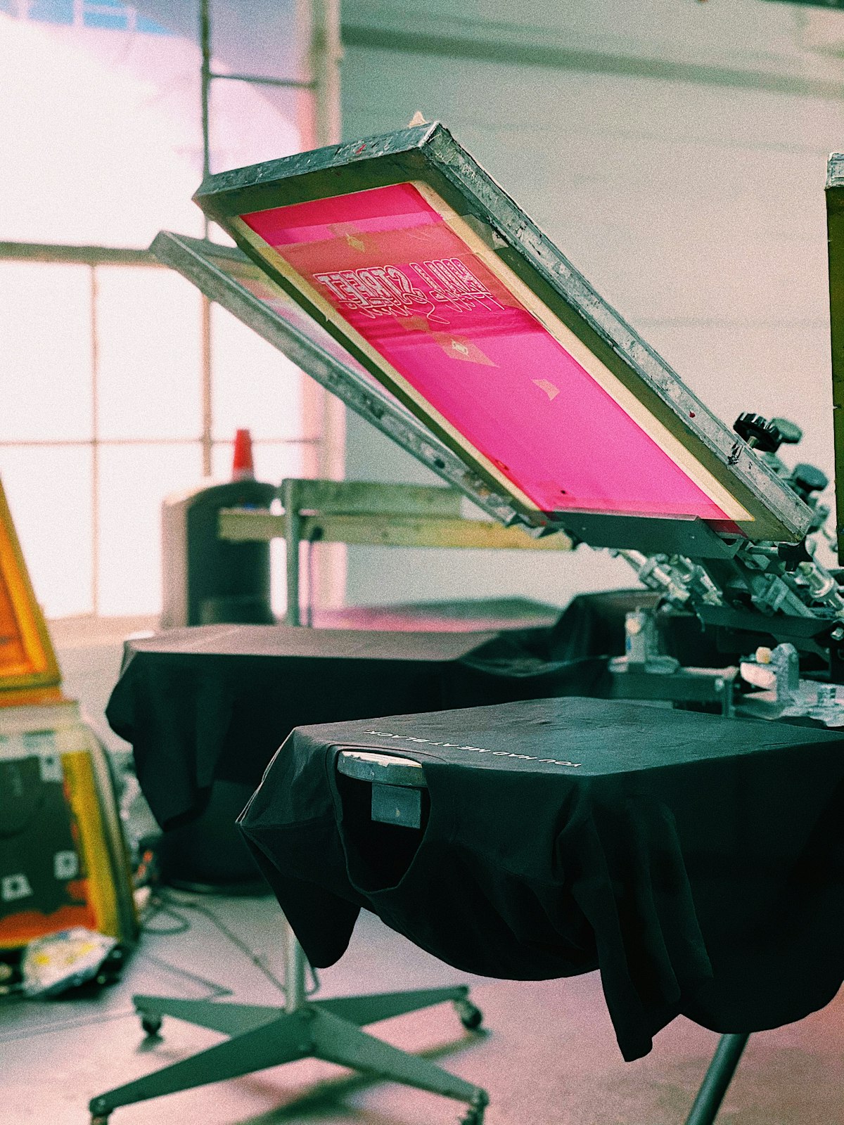 A screen printing carousel with a shirt loaded