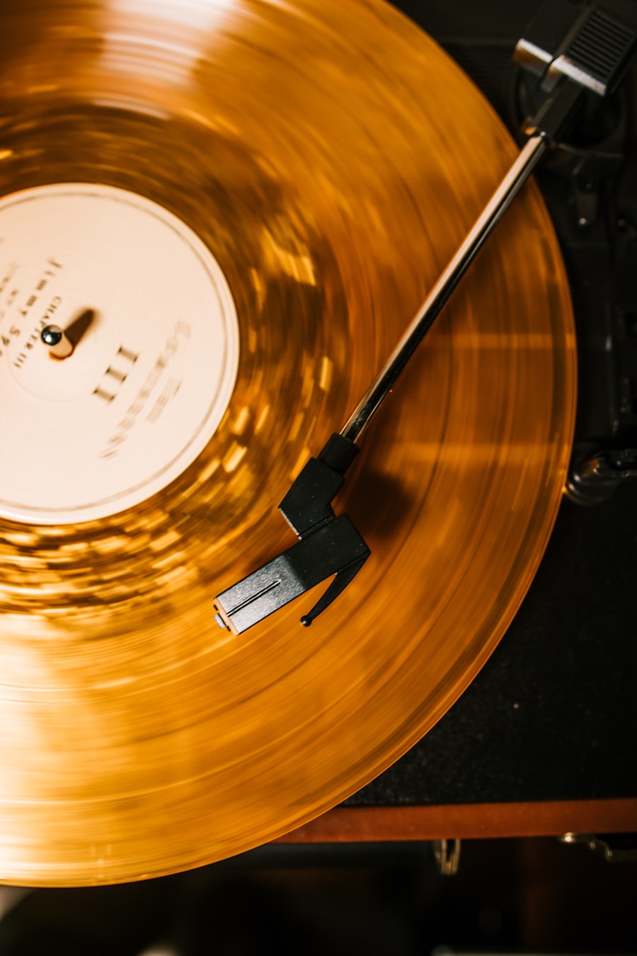 An amber colored record spinning on a turntable