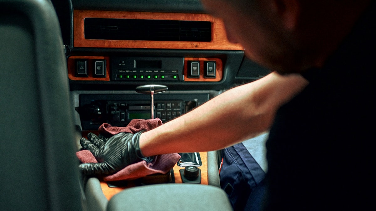 Crew member cleaning a car interior