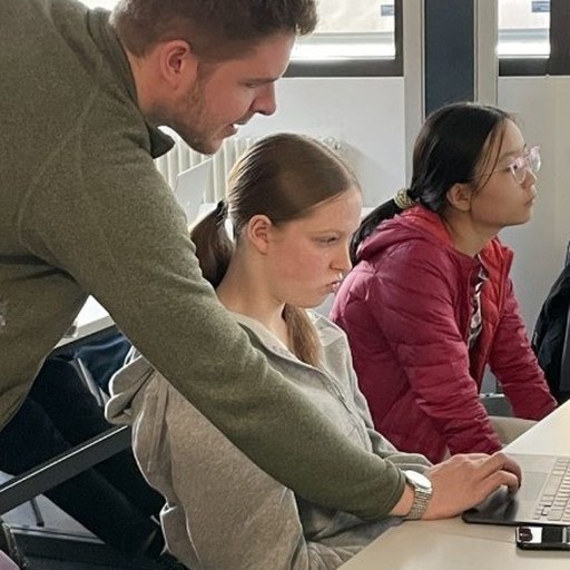 Students working on laptops in the AI and entrepreneurship class